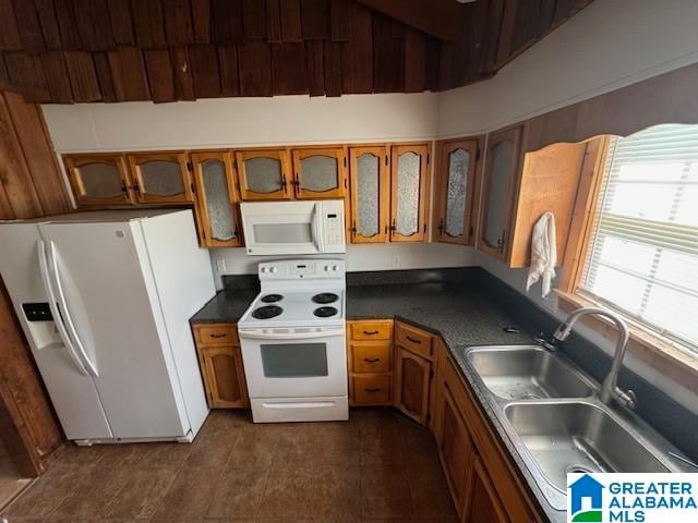 kitchen featuring white appliances and sink