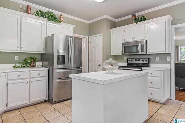 kitchen featuring a center island, crown molding, light tile patterned floors, white cabinetry, and stainless steel appliances