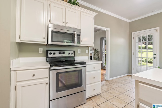 kitchen featuring crown molding, white cabinets, light tile patterned floors, and appliances with stainless steel finishes