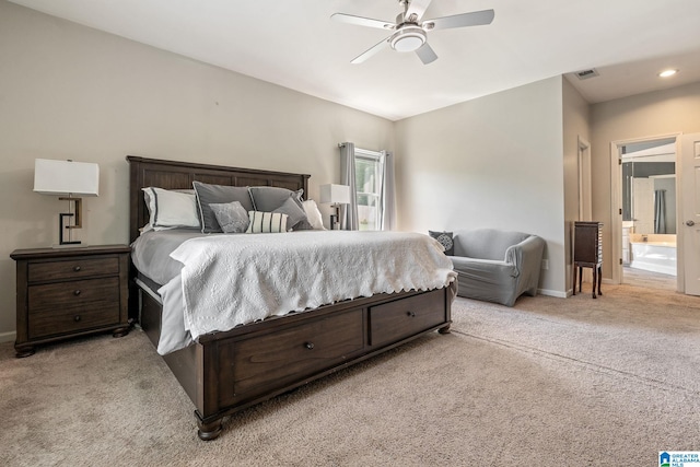 bedroom with ensuite bathroom, ceiling fan, and light colored carpet