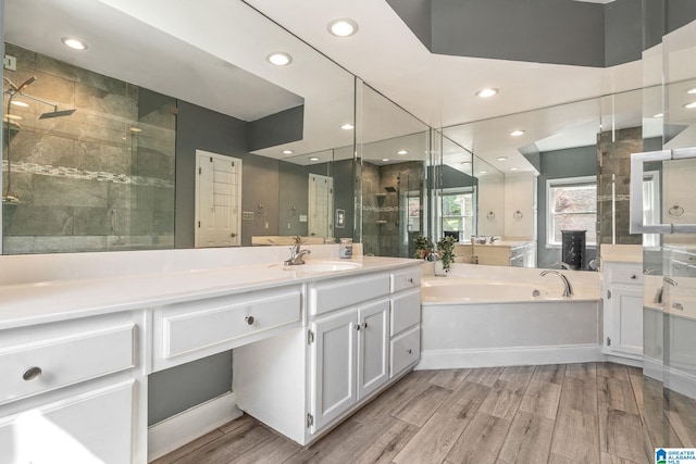 bathroom with vanity, separate shower and tub, and wood-type flooring