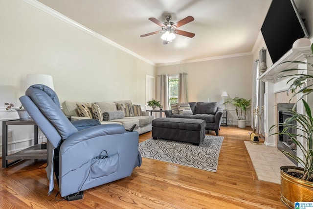 living room featuring crown molding and light hardwood / wood-style flooring