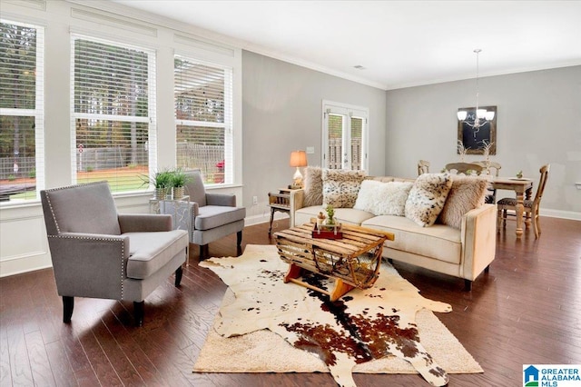 living room with crown molding, dark hardwood / wood-style flooring, and a notable chandelier