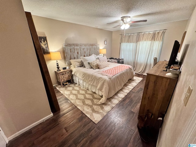 bedroom featuring ceiling fan, dark wood-type flooring, and a textured ceiling