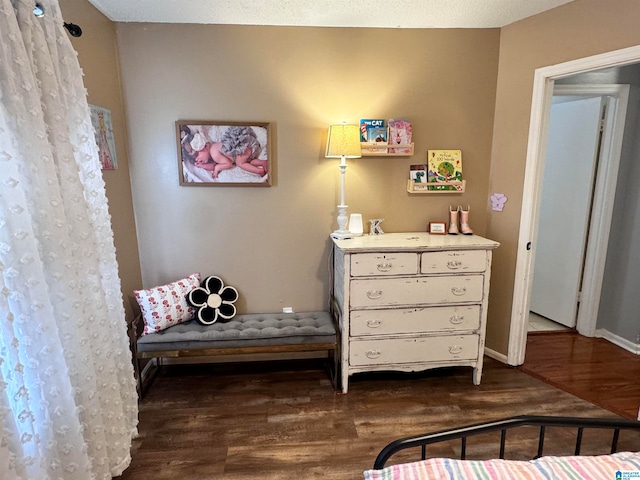 bedroom featuring a textured ceiling and dark hardwood / wood-style floors