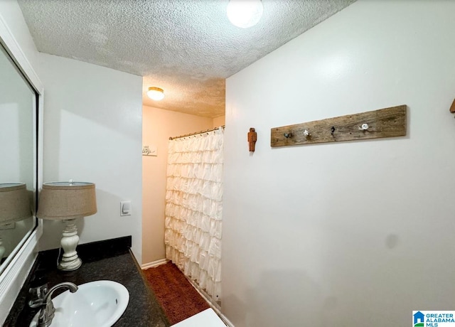 bathroom with vanity and a textured ceiling