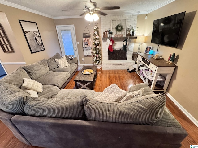 living room featuring hardwood / wood-style floors, a textured ceiling, and ornamental molding