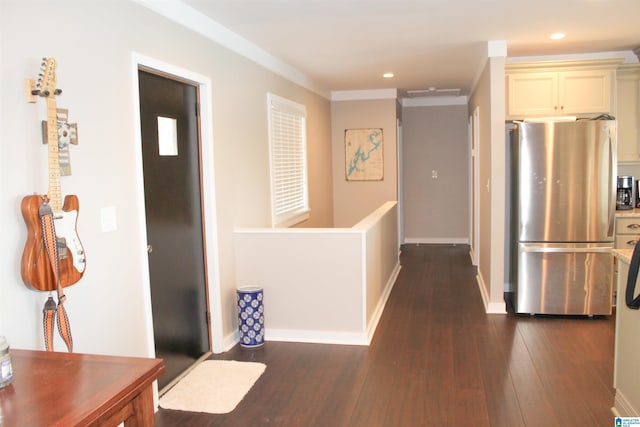 hall with dark hardwood / wood-style floors and ornamental molding