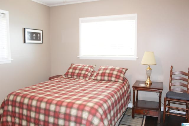 bedroom featuring ornamental molding and multiple windows