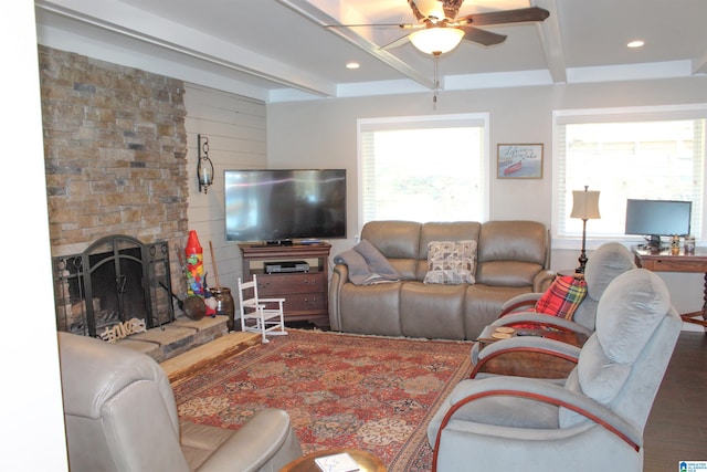 living room with beamed ceiling, plenty of natural light, ceiling fan, and wood-type flooring