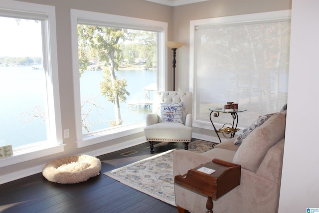 sitting room featuring hardwood / wood-style flooring and a water view