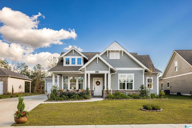 craftsman-style house with covered porch, a front lawn, and cooling unit