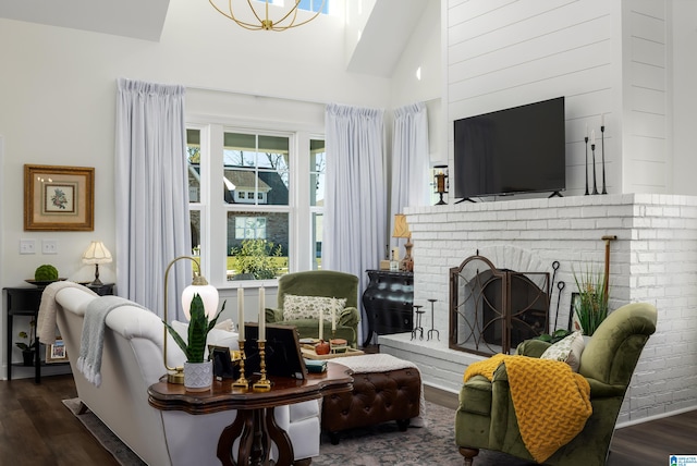 living room featuring dark hardwood / wood-style flooring, high vaulted ceiling, and a brick fireplace