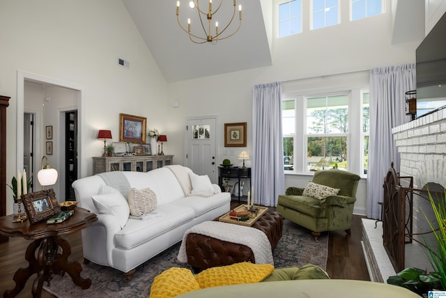 living room with a chandelier, high vaulted ceiling, and dark wood-type flooring