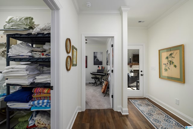 corridor featuring dark hardwood / wood-style floors and crown molding