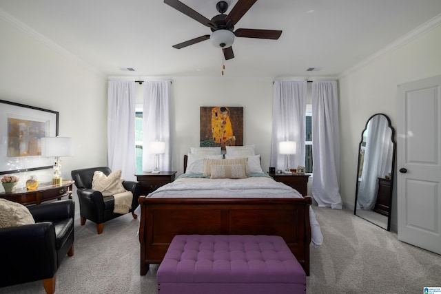 carpeted bedroom with ceiling fan and ornamental molding