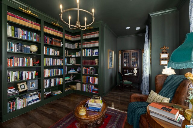 living area featuring crown molding, dark wood-type flooring, and a chandelier