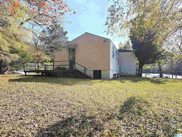 view of home's exterior featuring a yard and a wooden deck