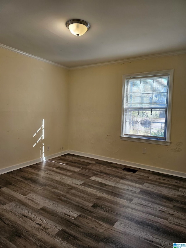 spare room featuring crown molding and dark hardwood / wood-style floors