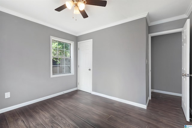 empty room featuring ceiling fan, ornamental molding, and dark wood-type flooring