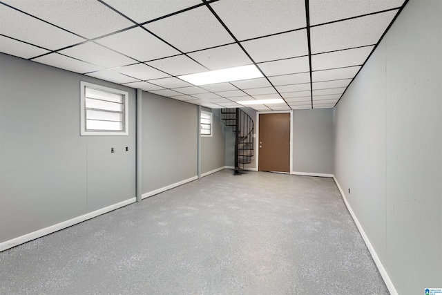 basement with a paneled ceiling