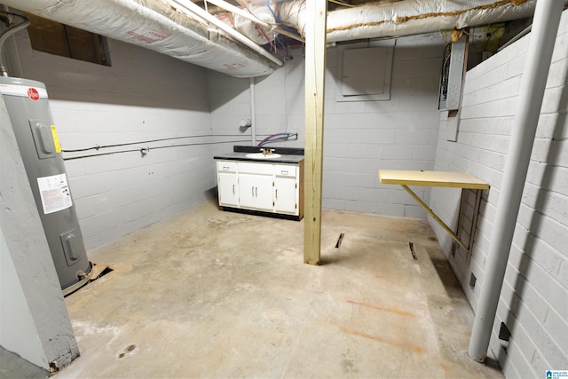 basement featuring water heater and sink