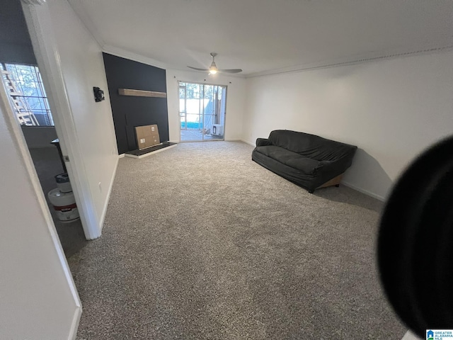 living area with carpet, ceiling fan, and crown molding