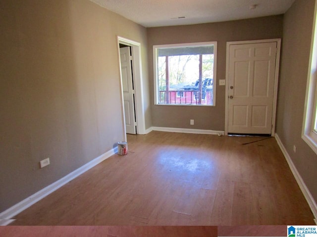 interior space featuring a textured ceiling and light hardwood / wood-style floors