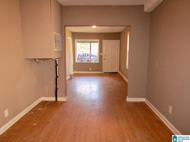 hallway with light hardwood / wood-style floors