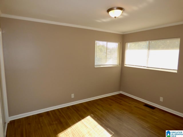 unfurnished room with hardwood / wood-style flooring and crown molding