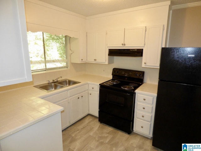 kitchen featuring white cabinetry, sink, tile counters, ventilation hood, and black appliances