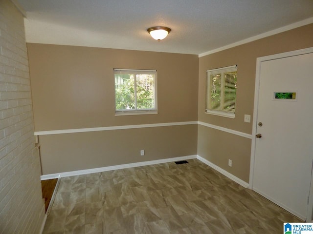 unfurnished room with a textured ceiling and hardwood / wood-style flooring