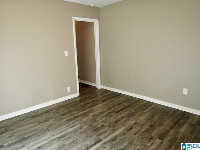 unfurnished room with dark hardwood / wood-style floors