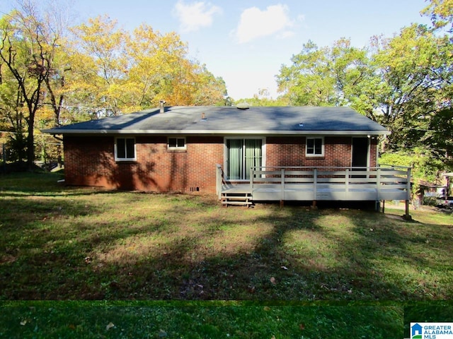 back of property featuring a yard and a wooden deck