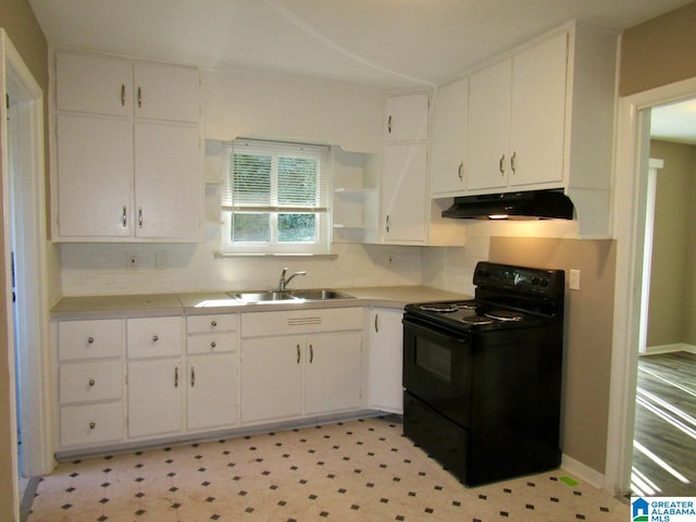 kitchen featuring black electric range, backsplash, white cabinets, and sink