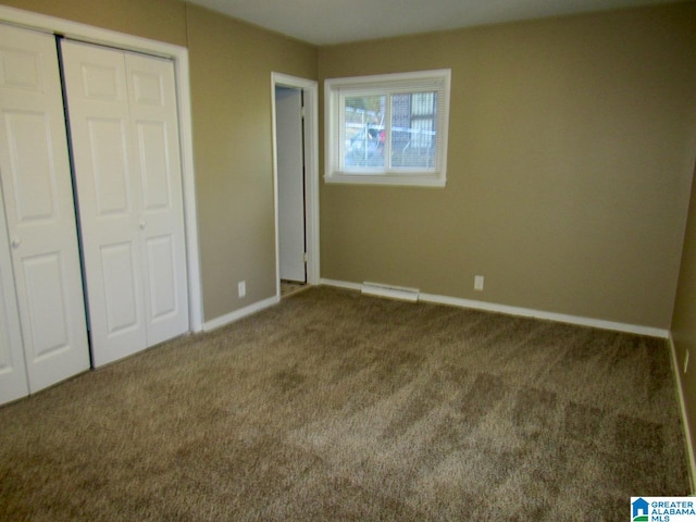 unfurnished bedroom featuring carpet flooring and a closet