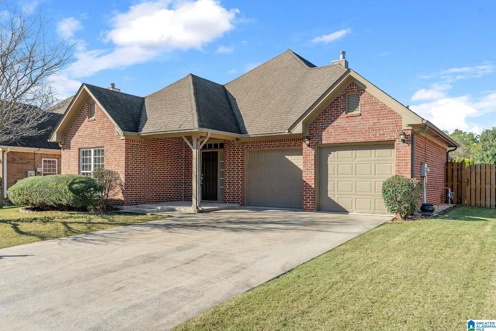 view of front facade with a front yard and a garage