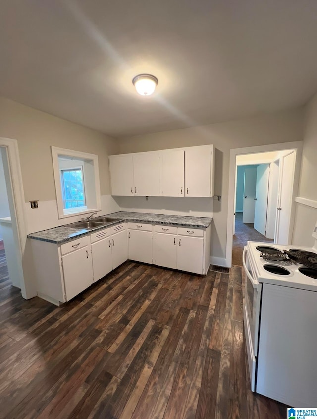 kitchen featuring white range with electric cooktop, dark hardwood / wood-style floors, white cabinets, and sink