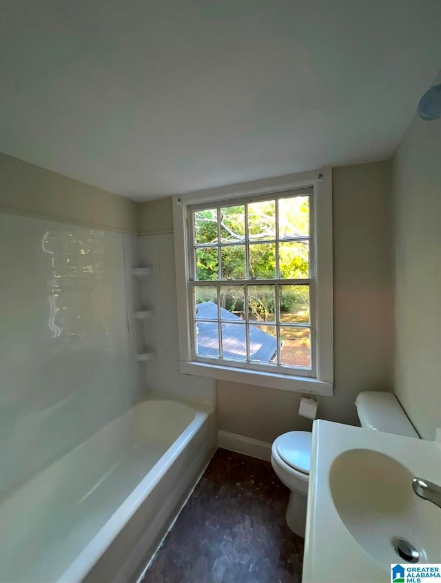 full bathroom with bathtub / shower combination, toilet, and sink