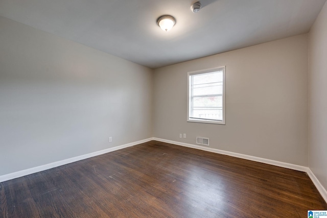 unfurnished room featuring dark hardwood / wood-style flooring