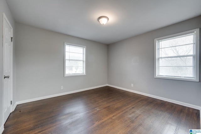 empty room with dark hardwood / wood-style floors