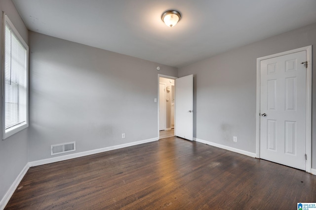 spare room featuring dark wood-type flooring