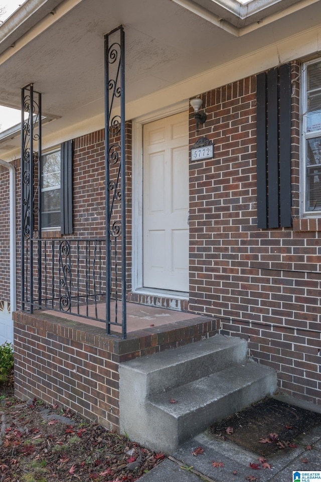 view of exterior entry with a porch