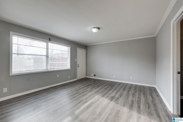 unfurnished room featuring ornamental molding and light hardwood / wood-style flooring