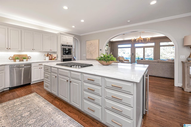 kitchen featuring a kitchen island, dark hardwood / wood-style flooring, and appliances with stainless steel finishes