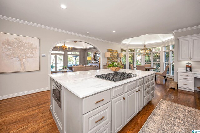 kitchen with dark hardwood / wood-style flooring, white cabinetry, and ornamental molding