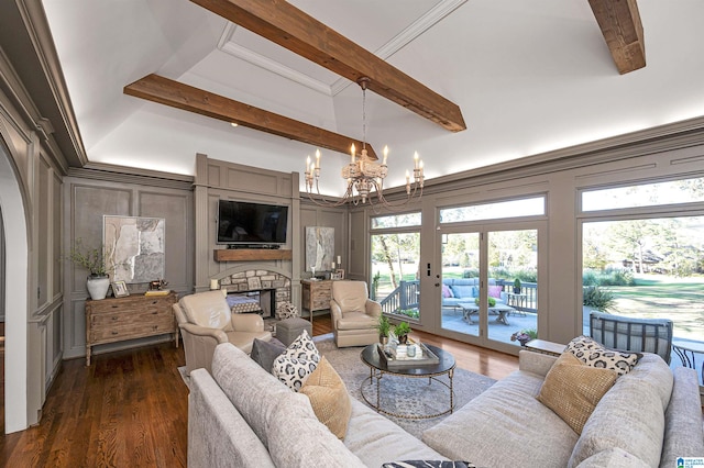 living room with french doors, dark hardwood / wood-style flooring, beam ceiling, a chandelier, and a stone fireplace