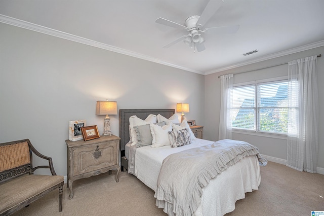 carpeted bedroom with ceiling fan and ornamental molding