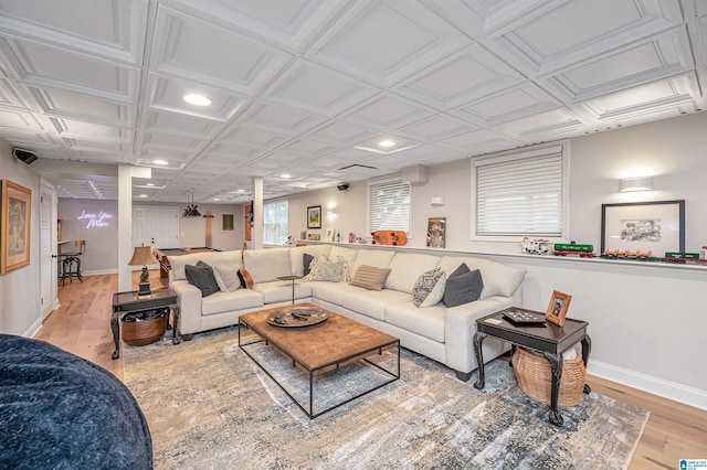 living room featuring light hardwood / wood-style flooring and coffered ceiling