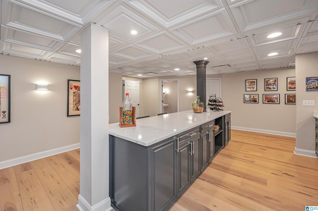 kitchen with light hardwood / wood-style floors and coffered ceiling